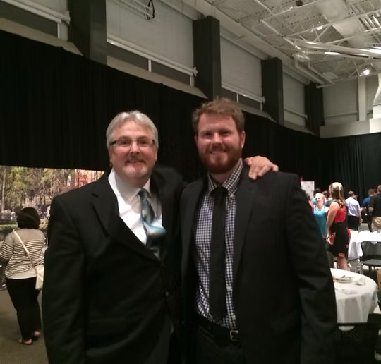 Dr. Joe and Dr. Joey Sennebogen standing together in the chiropractic office